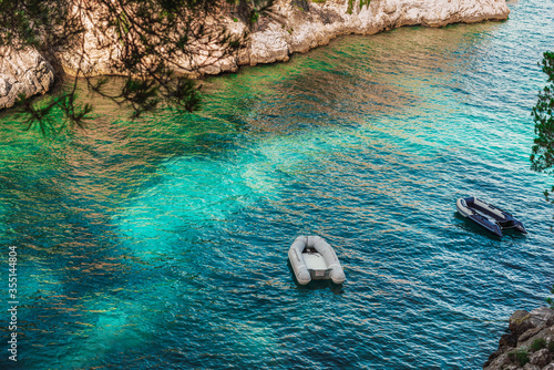 Natural landscape of cala Fornells, Mallorca. Seen from above, spectacular crystal clear water and boats, without people in june due to the covid-19