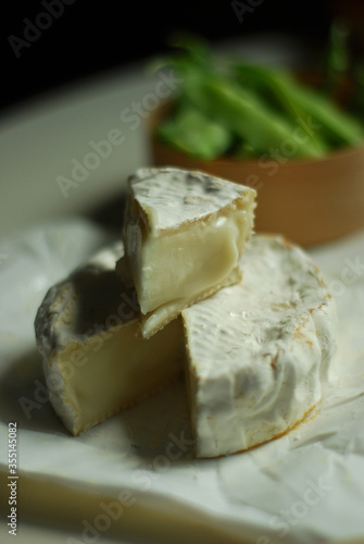 Fresh goat camembert and green pea pods