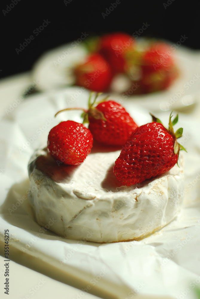 Fresh strawberries on Camembert cheese Fresh strawberries on Camembert cheese