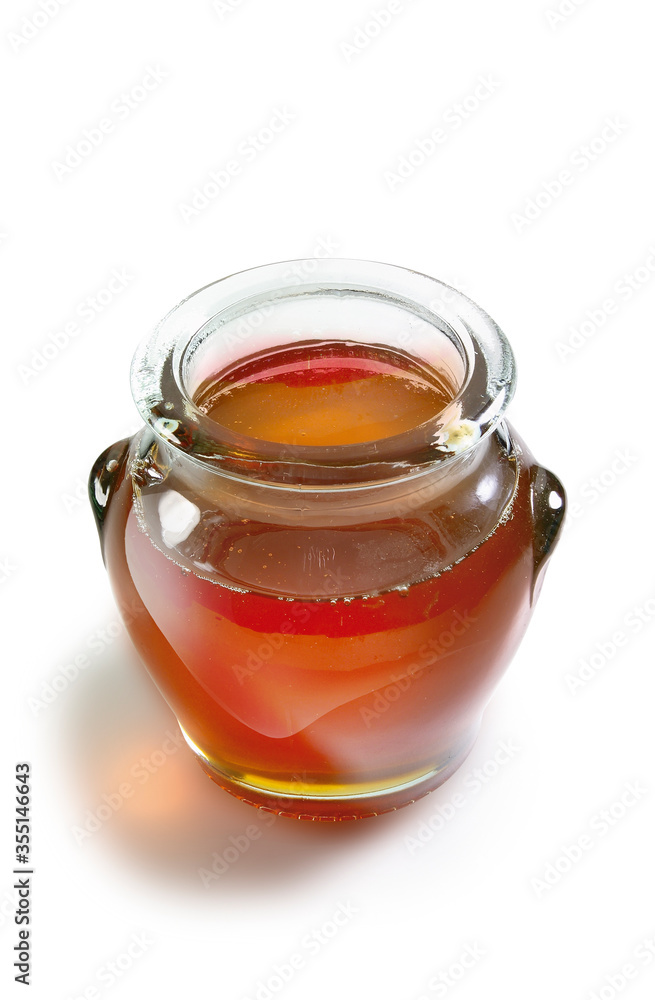 miel dulce en tarro de cristal sobre fondo blanco. sweet honey in glass jar on white background. miel dulce en tarro de cristal sobre fondo blanco. sweet honey in glass jar on white background.