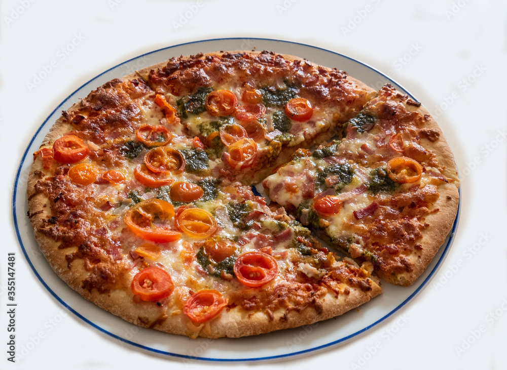 Sliced pizza on the white ceramic plate