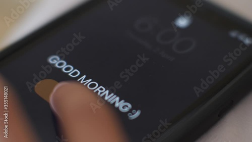 Good Morning alarm clock on the phone at 6 am. extreme close up.