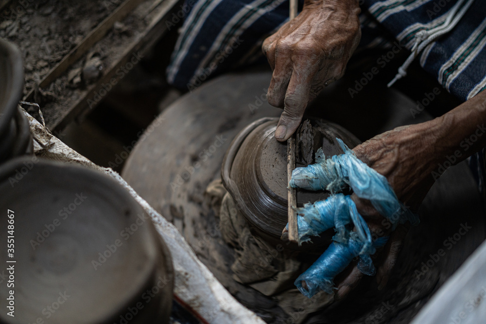 male potter is making a vase from clay, selective focus. male potter is making a vase from clay, selective focus.