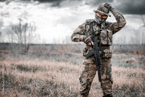 A man in a military uniform with a machine gun in his hands. Mobilization 2022