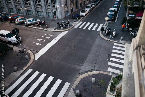 Fototapeta Naklejka Na Ścianę i Meble -  It's a beautiful intersection in the city. View from a window on an empty street in Europe. 