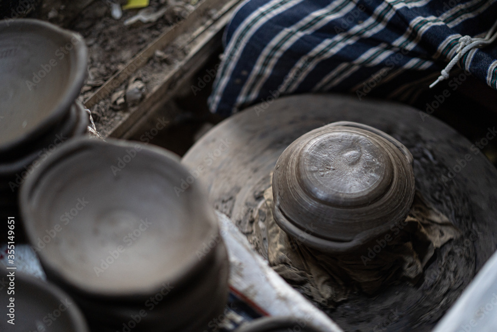 male potter is making a vase from clay, selective focus. male potter is making a vase from clay, selective focus.