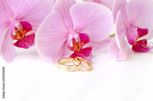 Wedding rings on background of orchids