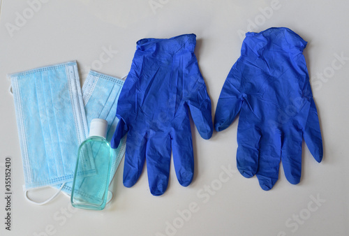 Medical background with hand sanitizer, surgical masks and latex rubber gloves, coronavirus protection concept, covid-19 prevention backdrop wallpaper