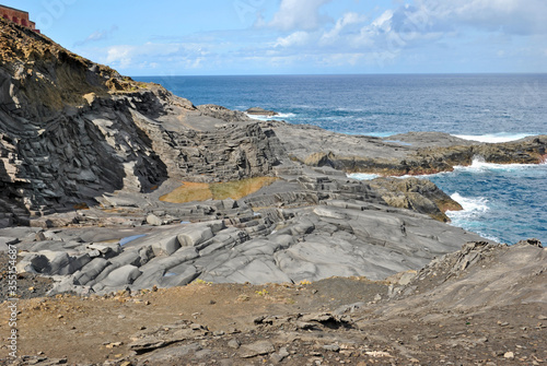 Layers of rocks resulting from lava flow - volcanic shore on the island of Gran Canaria, Canary Islands, Spain.