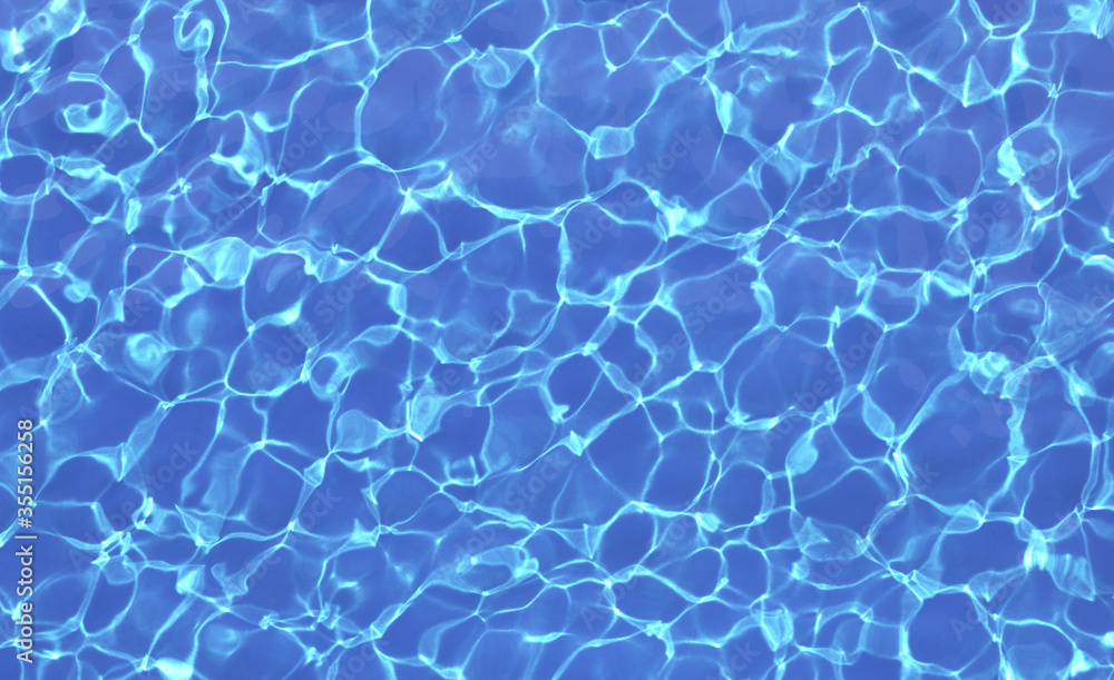 Blue water in swimming pool with sun reflections. Top view