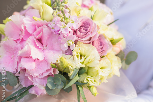 A large flower arrangement in a hat box was created by a florist for a valentine day gift. Pink Hydrangea, white roses and eucalyptus in a bouquet © Iryna