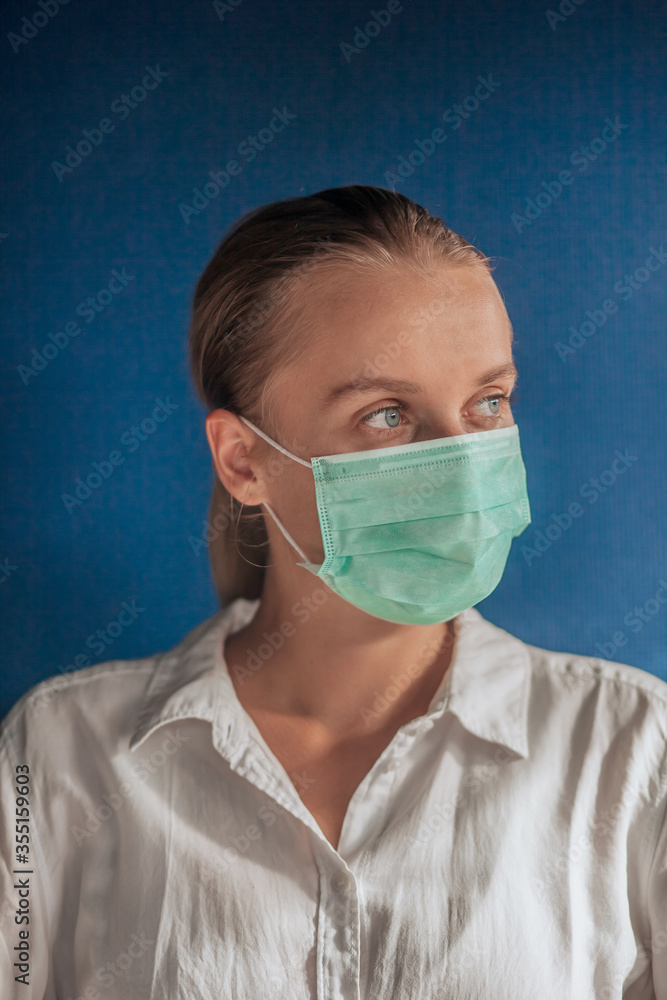 girl in a medical mask on a dark blue background