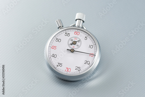 Analogue metal stopwatch on the gray background. 