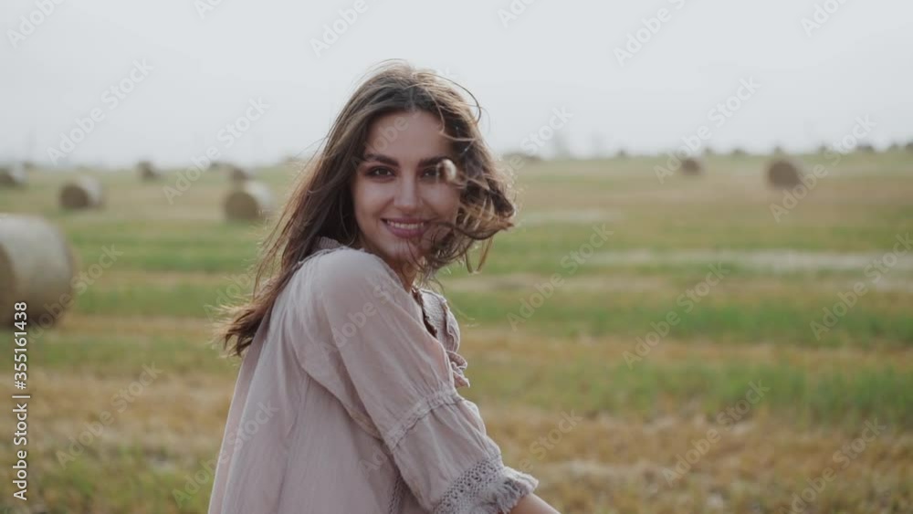 Girl in dress with a plaid in hands having fun with wind and rejoicing at camera Girl in dress with a plaid in hands having fun with wind and rejoicing at camera
