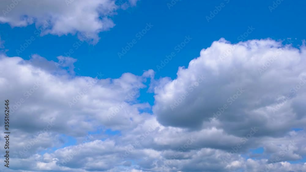 Thick white-gray clouds move quickly across the blue sky. Timelapse Thick white-gray clouds move quickly across the blue sky. Timelapse