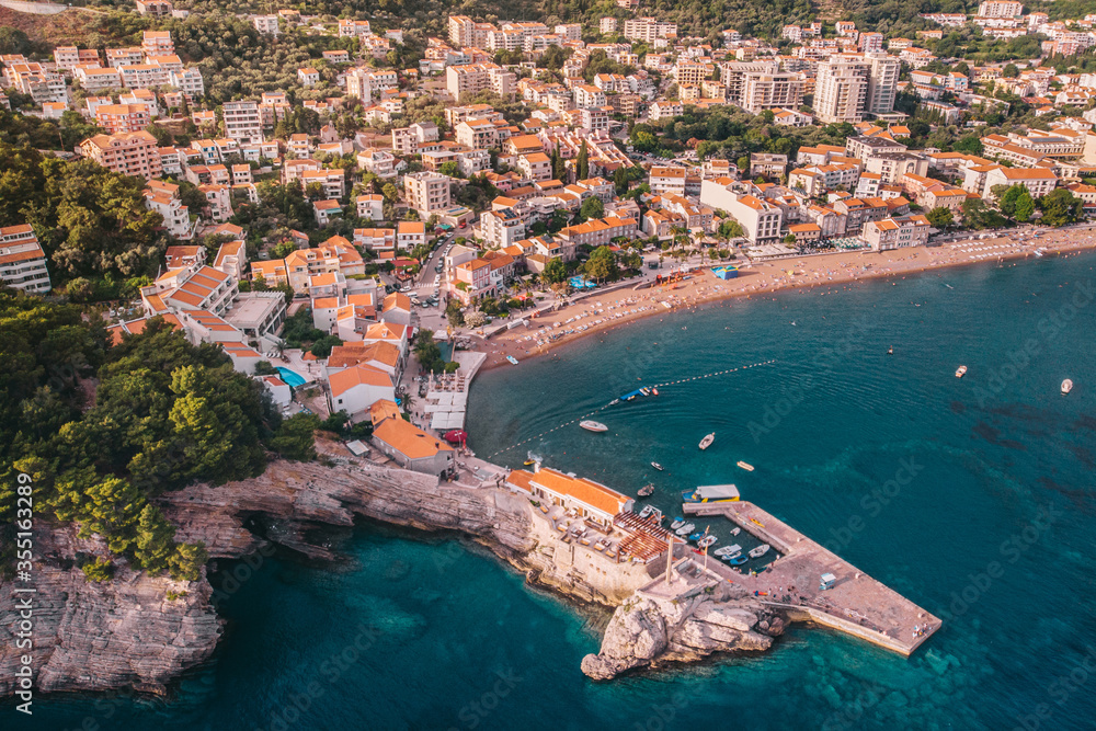 The ancient Mediterranean resort town of Petrovac in Montenegro, aerial view on a sunny day.
