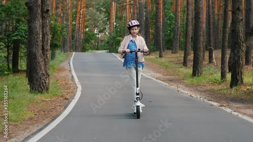Wallpaper Mural Girl rides electric scooter on the way to the park Torontodigital.ca