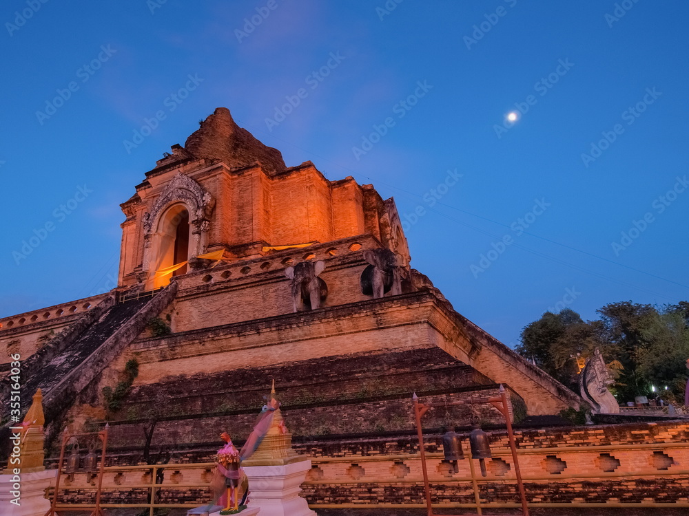 view evening of ruin pagoda lanna style art 13th. Century with blue sky background, Wat Chedi Luang buddhist temple in Chiang Mai, northern of Thailand.