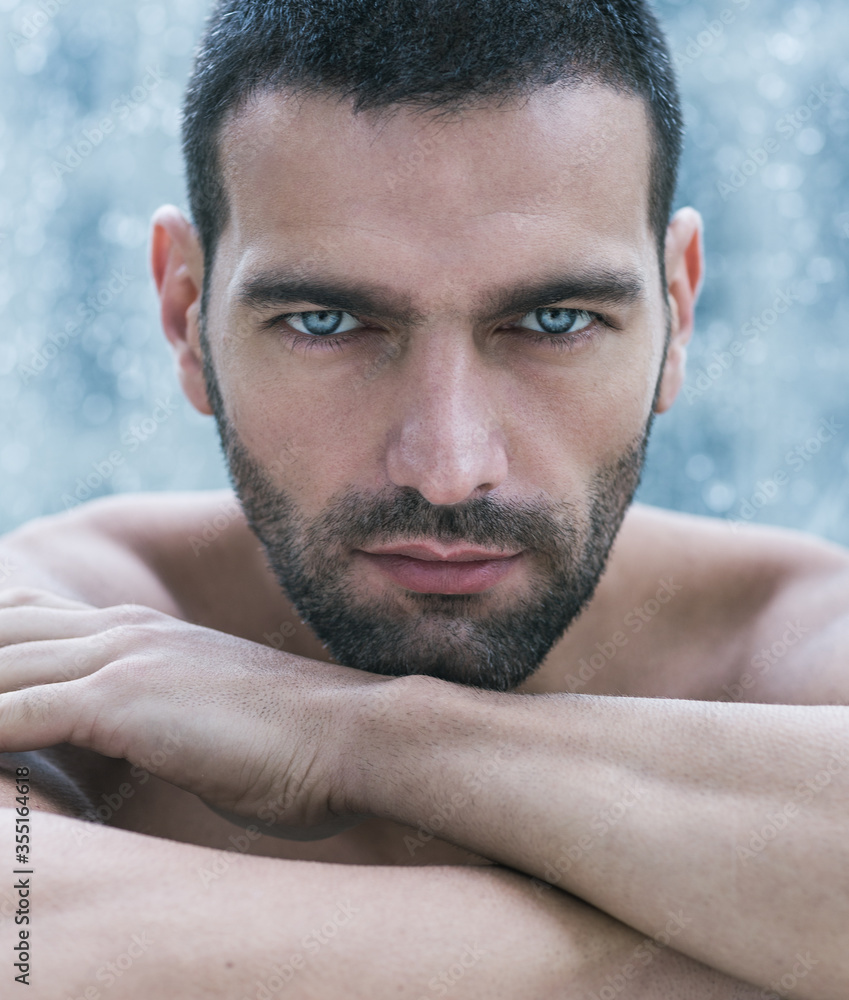 Sexy Closeup Portrait Of Nude Handsome Male Model With Powerful Blue