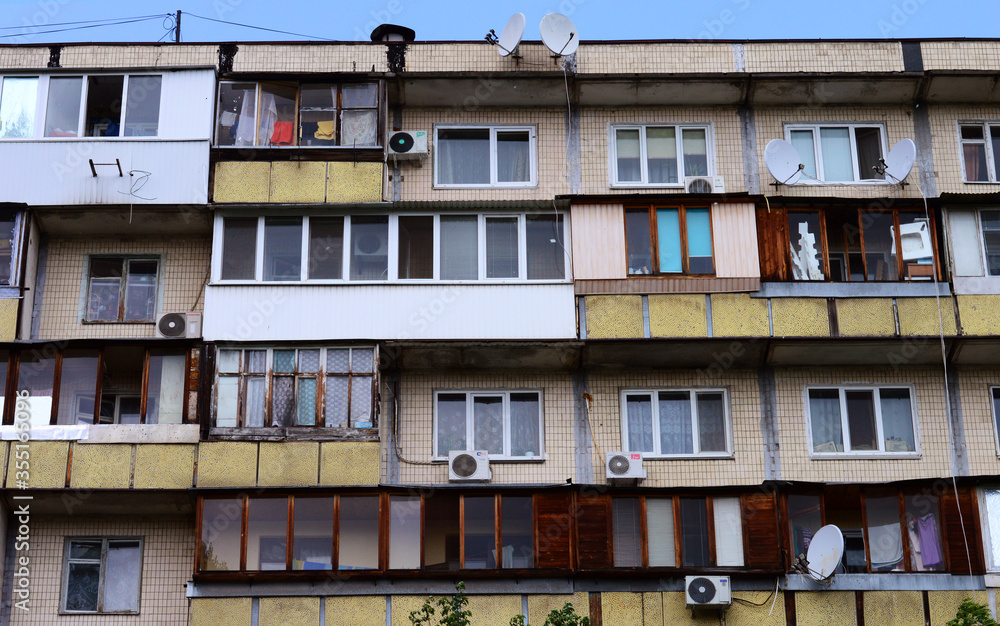 facade of an old building. poor  flats. windows and balconies of their poor apartments. soviet house