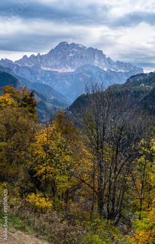 Autumn alpine Dolomites scene. Monte Civetta mountain top in far view from Livinallongo del Col di Lana, Belluno, Italy.