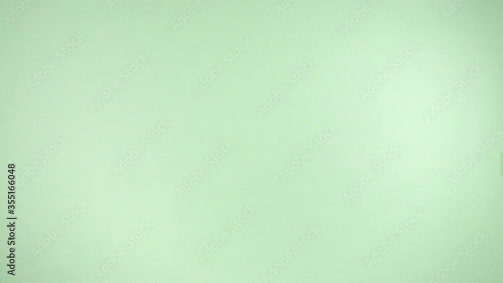 Super slow motion of a group of flying butter cookies with circle shape. Lovely biscuits rotation on a green background.