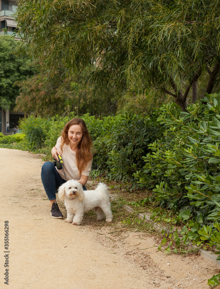 Beautiful young girl on a walk in the Park with her dog. Beautiful young girl on a walk in the Park with her dog.