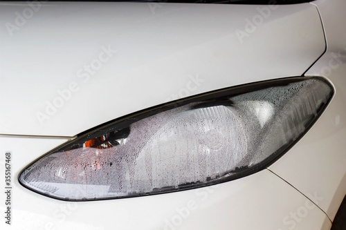 Vapor inside headlight of a car automotive background