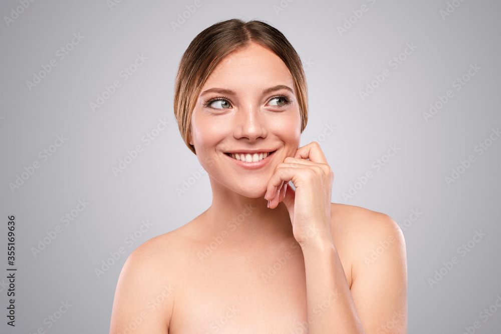 Cheerful woman with clean skin looking away Cheerful woman with clean skin looking away