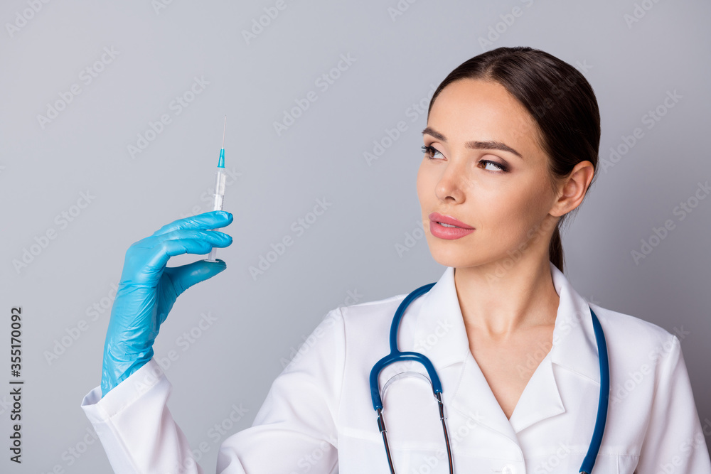 Closeup photo of professional doc hold syringe preparing patients vaccination antibiotic wear latex gloves medical uniform lab coat stethoscope isolated grey background Closeup photo of professional doc hold syringe preparing patients vaccination antibiotic wear latex gloves medical uniform lab coat stethoscope isolated grey background