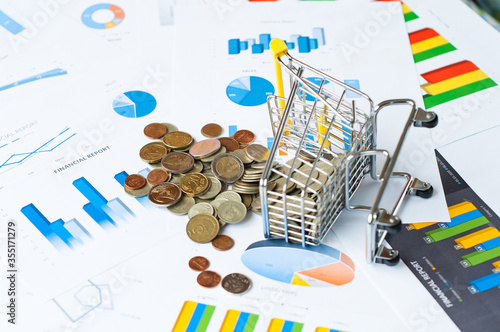 Detail view of piggy bank with coins on table