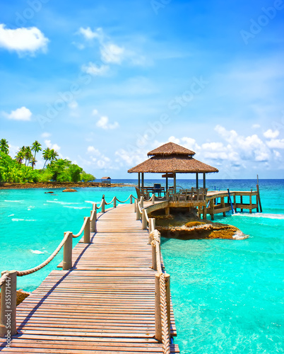 Sea with pier under blue cloudy sky © preto_perola