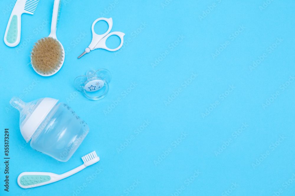 Sweet baby accessories on blue background . Copy space Top view Flat lay.