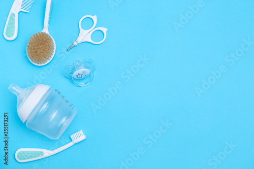 Sweet baby accessories on blue background . Copy space Top view Flat lay.
