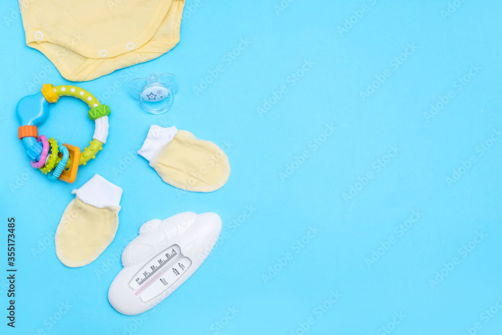 Lovely baby accessories on blue background . Copy space Top view Flat lay. Lovely baby accessories on blue background . Copy space Top view Flat lay.