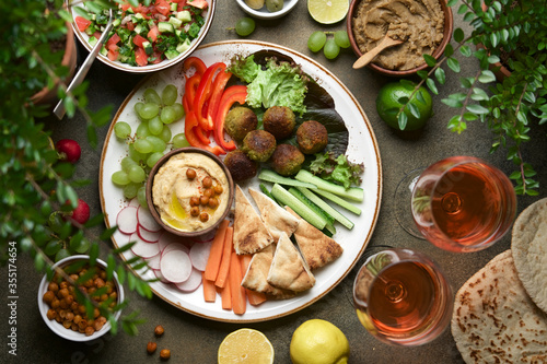 Festive dinner table with hummus plate and appetizers. Meze party food. Top view  flat lay