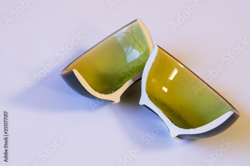 Obraz na płótnie Two broken pieces of a small ceramic bowl on the white background