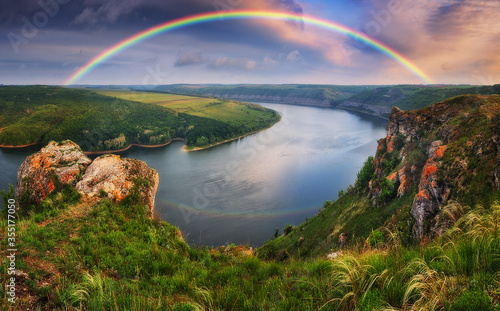 colorful rainbow over river canyon