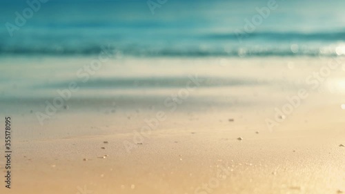 Sea beach background in Thailand by blurring the waves ( bokeh ) and focus on the beach front during the daytime of the summer holiday for tourism , travel , vacation and relaxation spa concept
