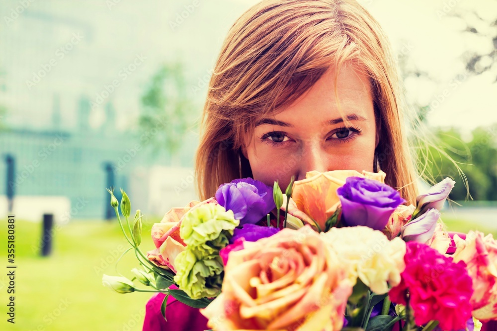 Portrait of young attractive woman holding boquet of flowers
Portrait of young attractive woman holding boquet of flowers
