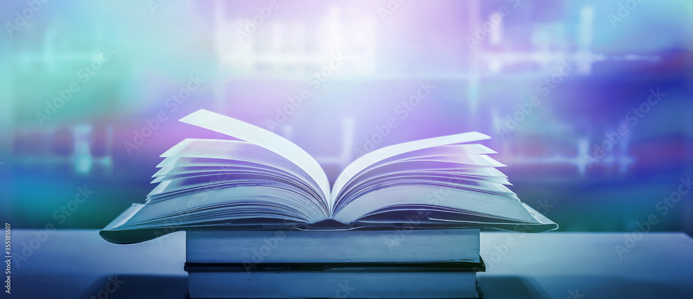 Stack of books in the library and blur bookshelf background Stack of books in the library and blur bookshelf background