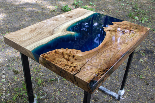 Beautiful wooden table made of elm slab with epoxy resin filling