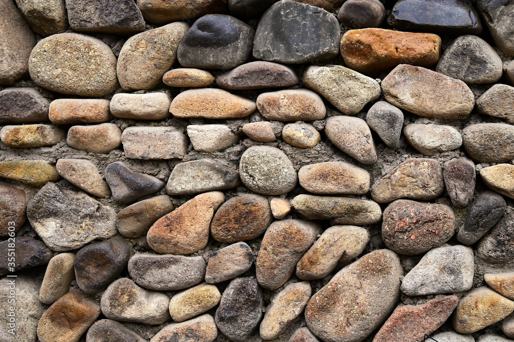Wall background of rural buildings paved with large cobblestones Wall background of rural buildings paved with large cobblestones