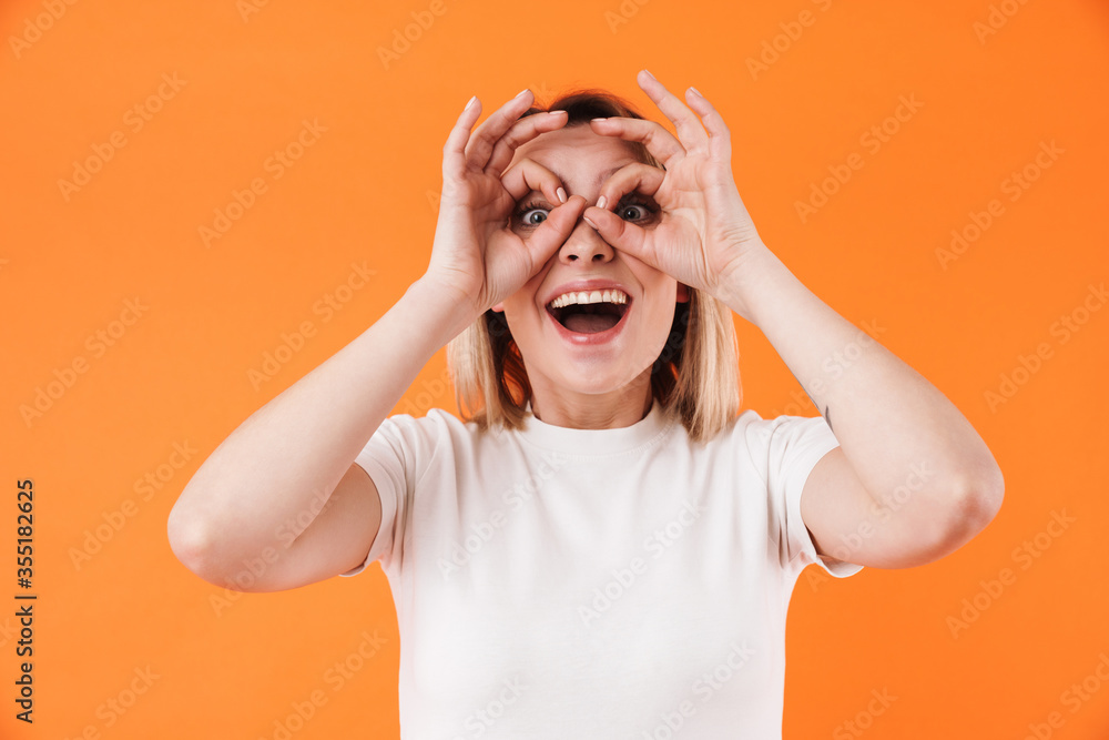 Image of excited attractive woman smiling and gesturing ok sign Image of excited attractive woman smiling and gesturing ok sign