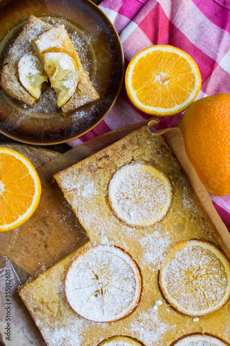 Homemade citrus tart with slices of lemon and oranges on top.