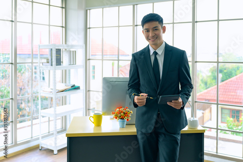 Wallpaper Mural Portrait of young man in office. Entrepreneur businessman working in the office. Torontodigital.ca