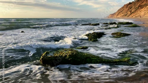 Waves of Mediterranean Sea rolling to shore at Sharon Beach National Park, Central Israel photo