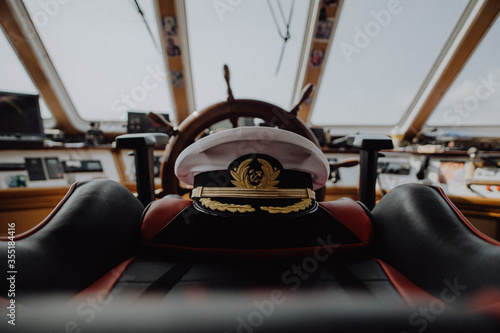Captains hat left on the captains char on an old ship
