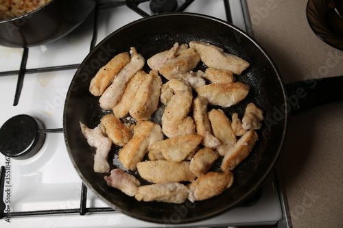 Pieces of chicken fillet fried in a pan. Cooking Sliced ​​Chicken Fillet.