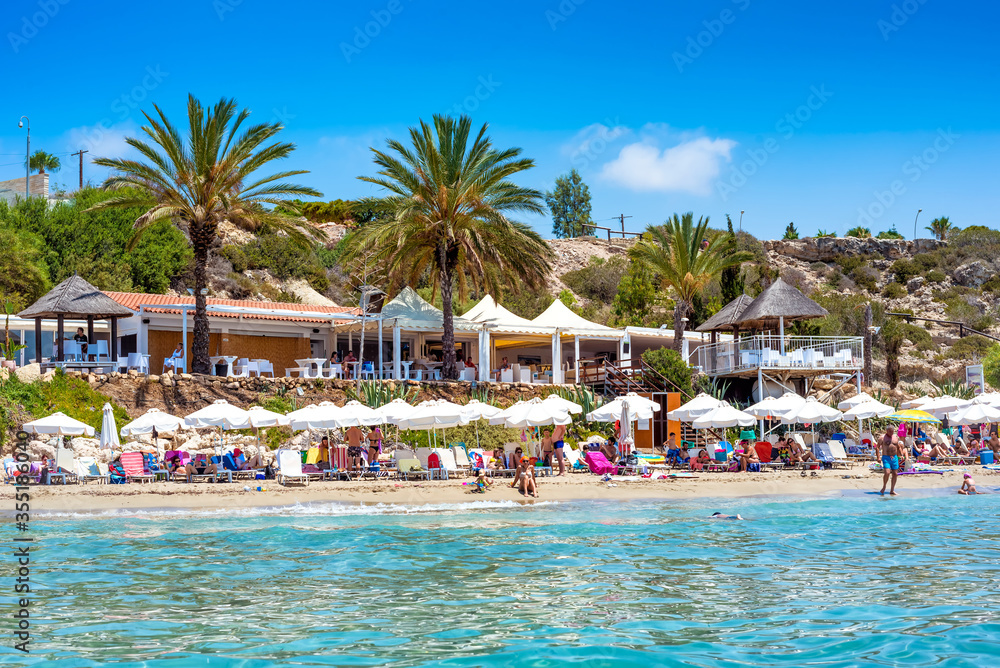 People relaxing on Coral Bay Beach, one of the most famous beaches in Cyprus. People relaxing on Coral Bay Beach, one of the most famous beaches in Cyprus.